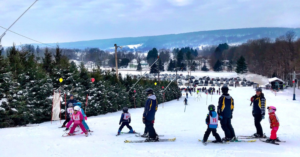 a group of people riding skis on top of a snow covered slope