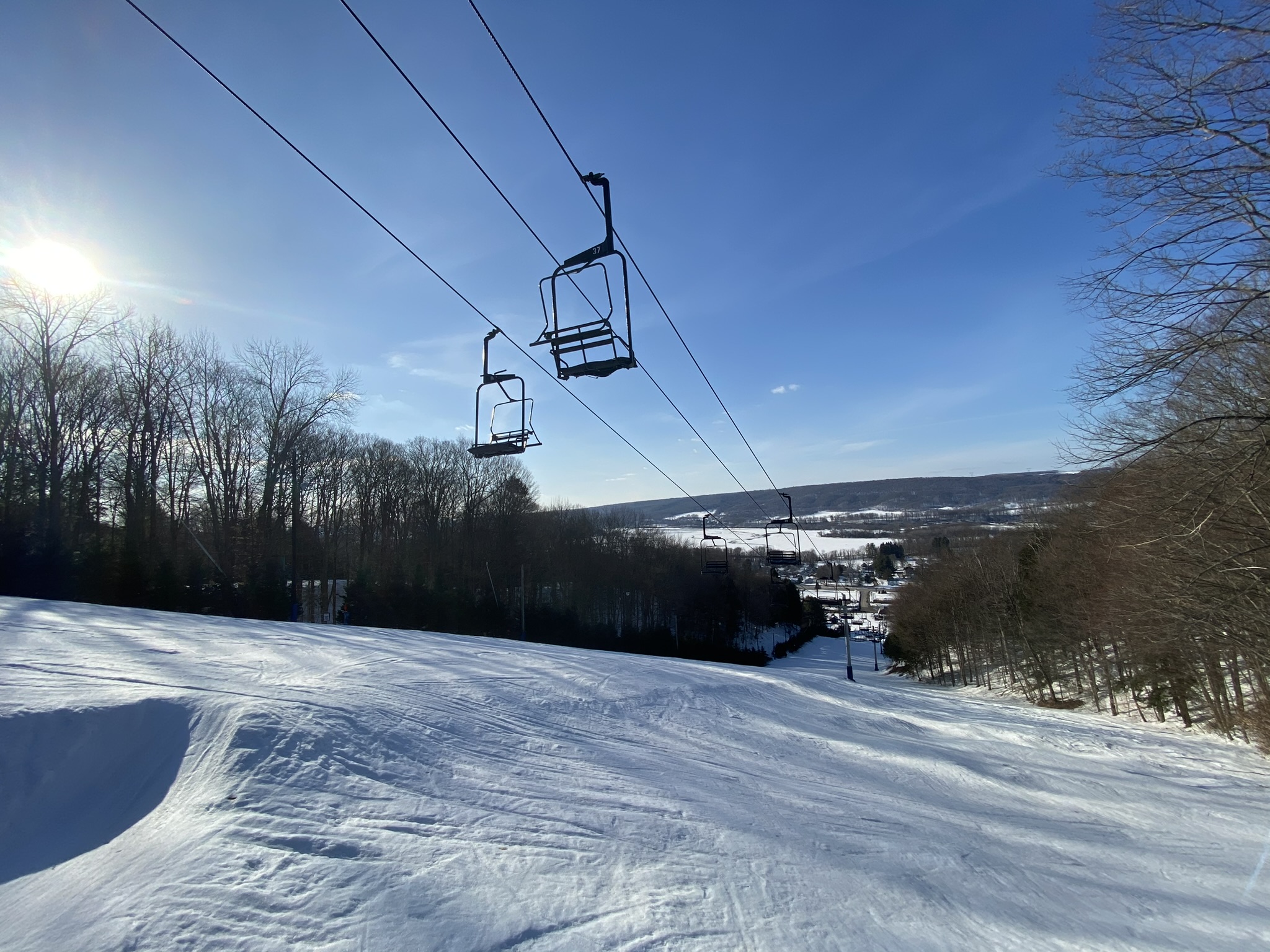 a man flying through the air on a snow covered slope